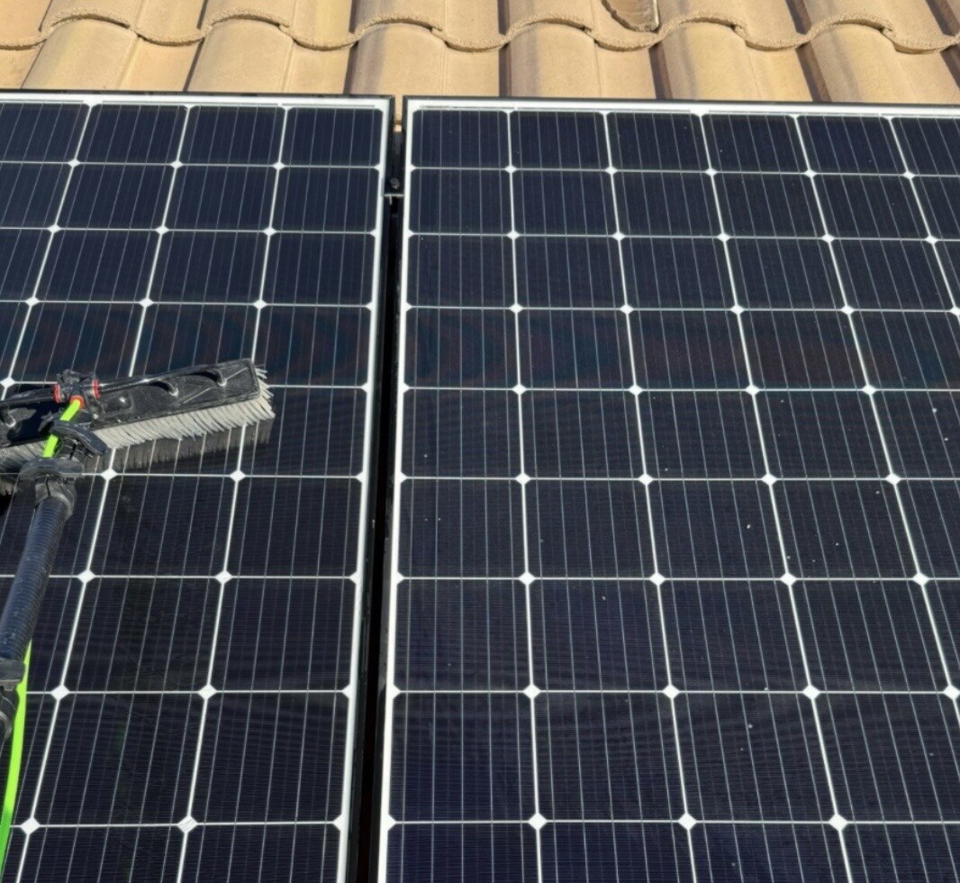 Solar panel cleaning, brushing dust and grime off rooftop solar panels
