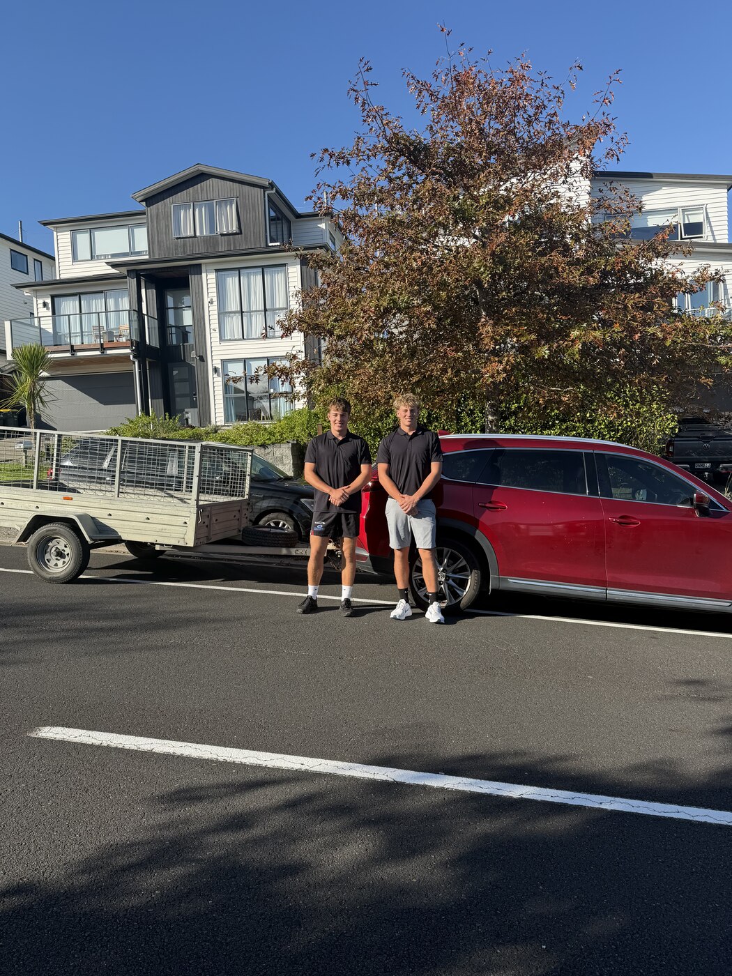 Jacob and Arlo, founders of Luck's Cleaning Services, with their vehicle and trailer